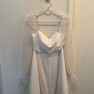 Elegant White Dress with Sheer Polka Dot Sleeves